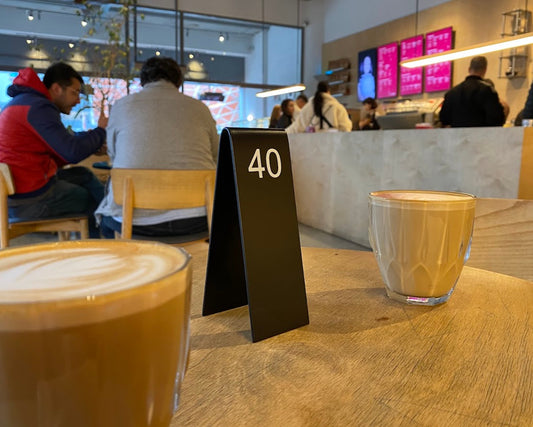 "Custom-made double-sided table numbers, personalized with logo printing and QR code options. Ideal for small businesses, cafes, and boutique shops."

