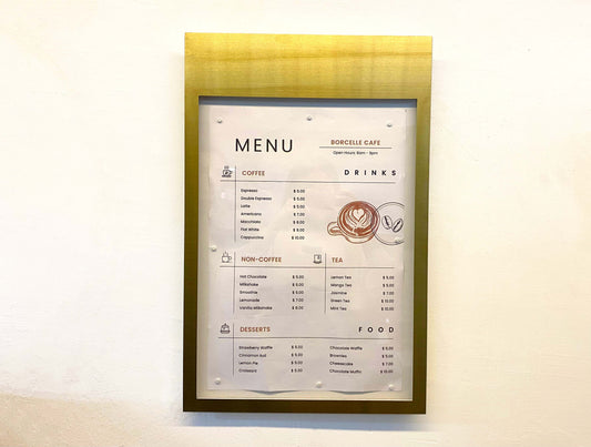 Featuring a sliding transparent cover, this brass-framed magnetic menu box offers both practicality and elegance as a wall-mounted display.

